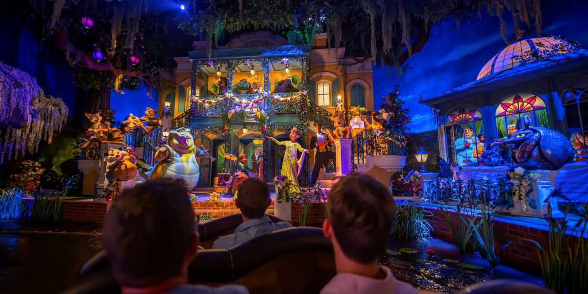 Guests riding through the finale on Tiana's Bayou Adventure