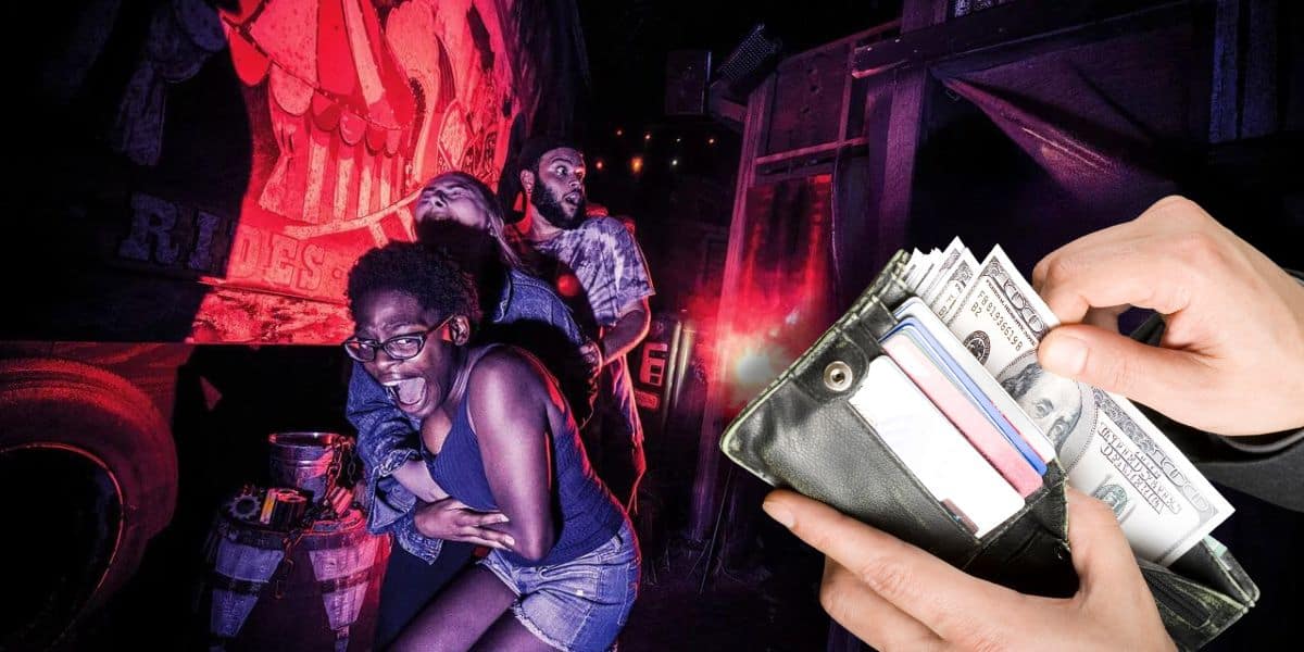 A group of three people scream and hold onto each other in fright as they navigate a dark, haunted house at Halloween Horror Nights. On the right side of the image, a close-up of hands holding an open wallet with cash and cards is visible.