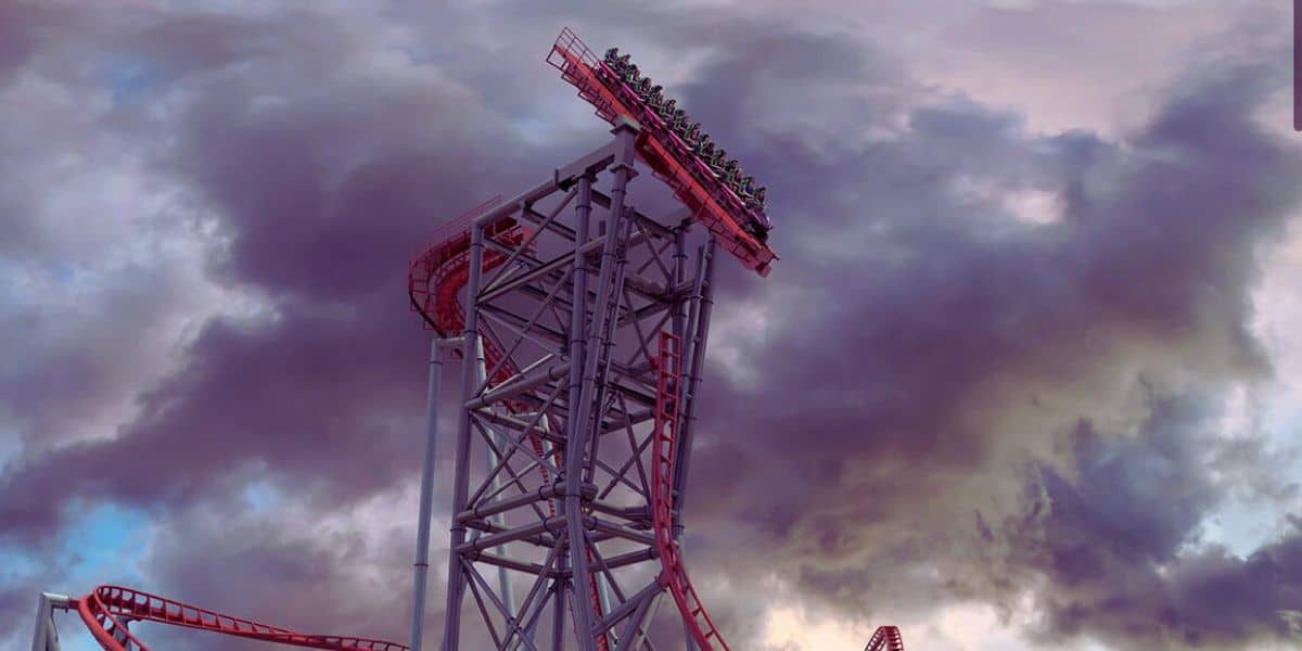 A vibrant, towering roller coaster inside Cedar Point titled Siren's Curse looms against a dramatic sky filled with dark, swirling clouds in North America. The steep drop is filled with riders holding on, facing an intense descent. Known as the fastest coaster, its red tracks and metallic structure contrast with the tumultuous backdrop.