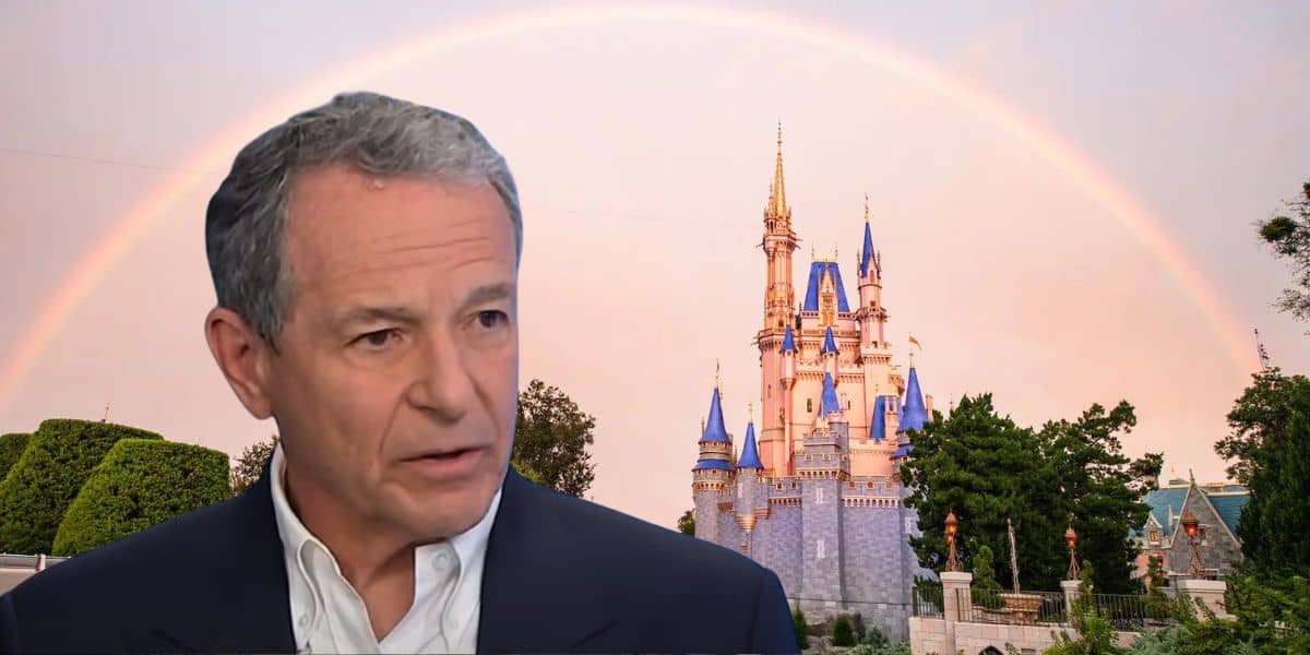 Bob Iger looking troubled against Disney World Castle, which is under a rainbow.