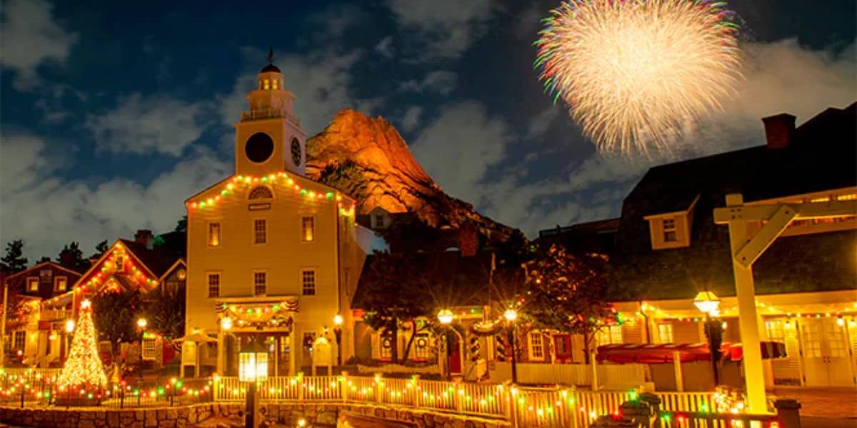 Fireworks in the sky above a quaint village land in Tokyo DisneySea.