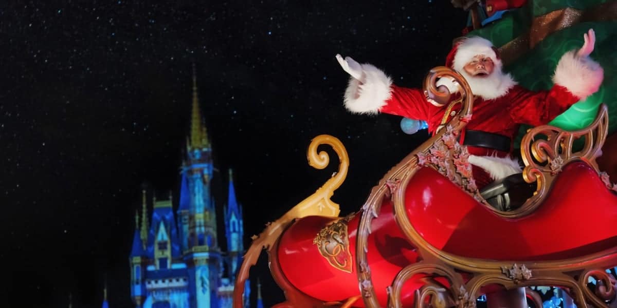 Santa Claus rides in a festive red sleigh, joyfully waving against a backdrop of a starlit night and an illuminated castle. The scene exudes holiday spirit and magic.