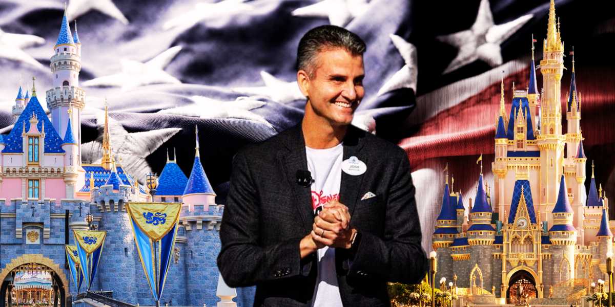 Josh D'Amaro in front of United States of America flag, with Sleeping Beauty Castle (L) and Cinderella Castle (R)