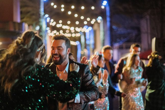 Guests dance at Holiday Fiesta en la Calle