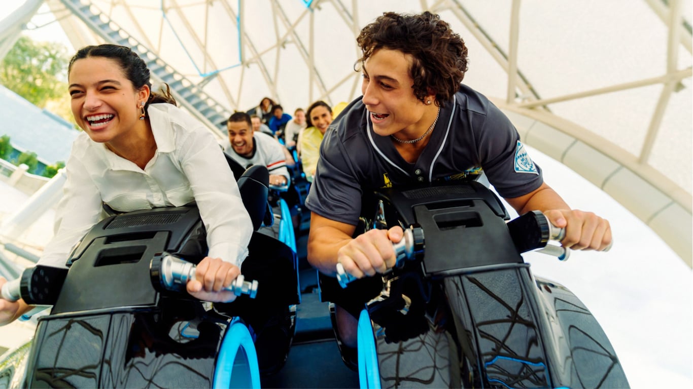 Guests riding on the Tron Lightcycle Run attraction 