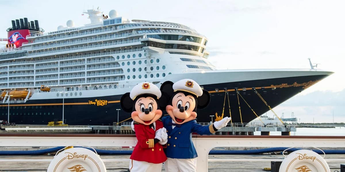 Mickey and Minnie in front of a Disney Cruise ship