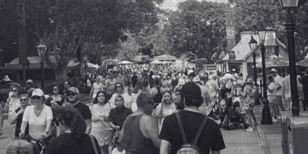 A black and white photo of crowds in the EPCOT World Showcase.