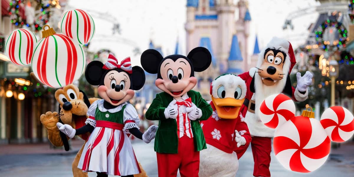 Five cartoon characters, including Mickey Mouse, a duck, and a dog, dressed in festive holiday attire, stand on a Disney Magic-inspired street with a castle in the background. Large Christmas-themed ornaments are visible around them.