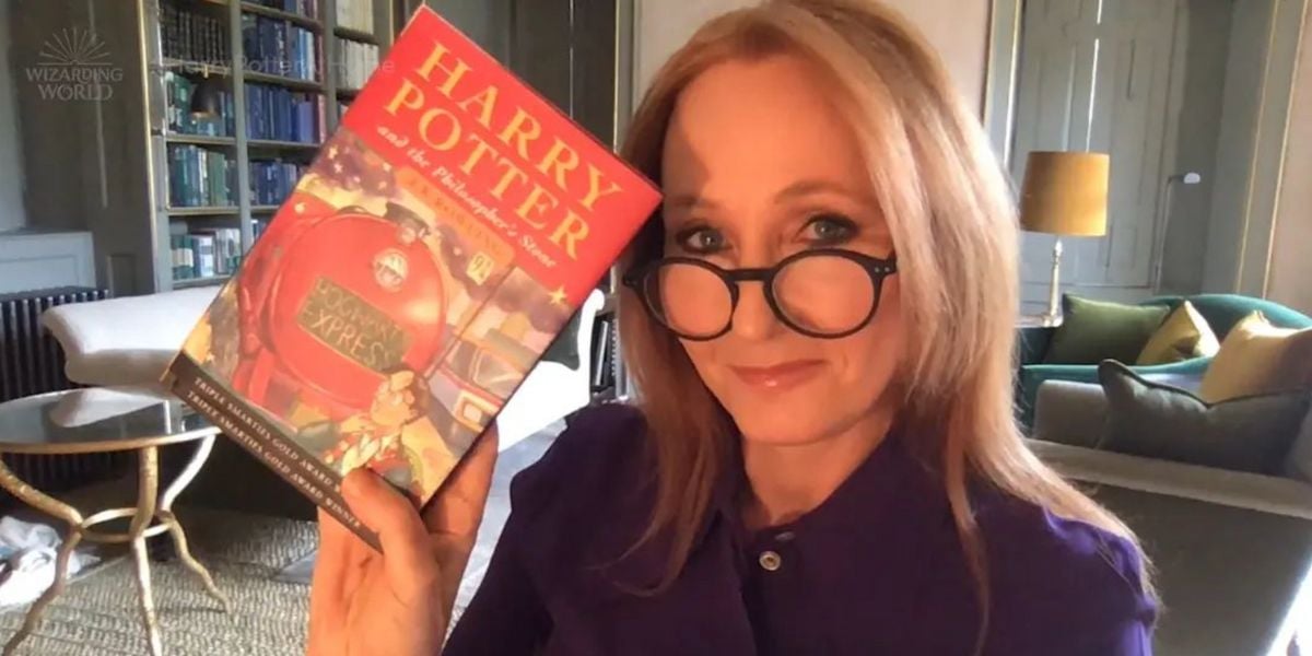 JK Rowling poses with a copy of 'Harry Potter and the Sorcerer's Stone'