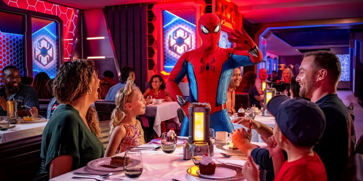 A family meets Spider-Man while dining on the Disney Treasure, a Disney Cruise Line ship