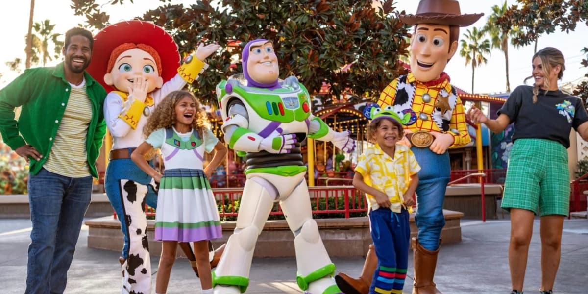 Jessie, Buzz Lightyear, and Woody from Toy Story posing with guests