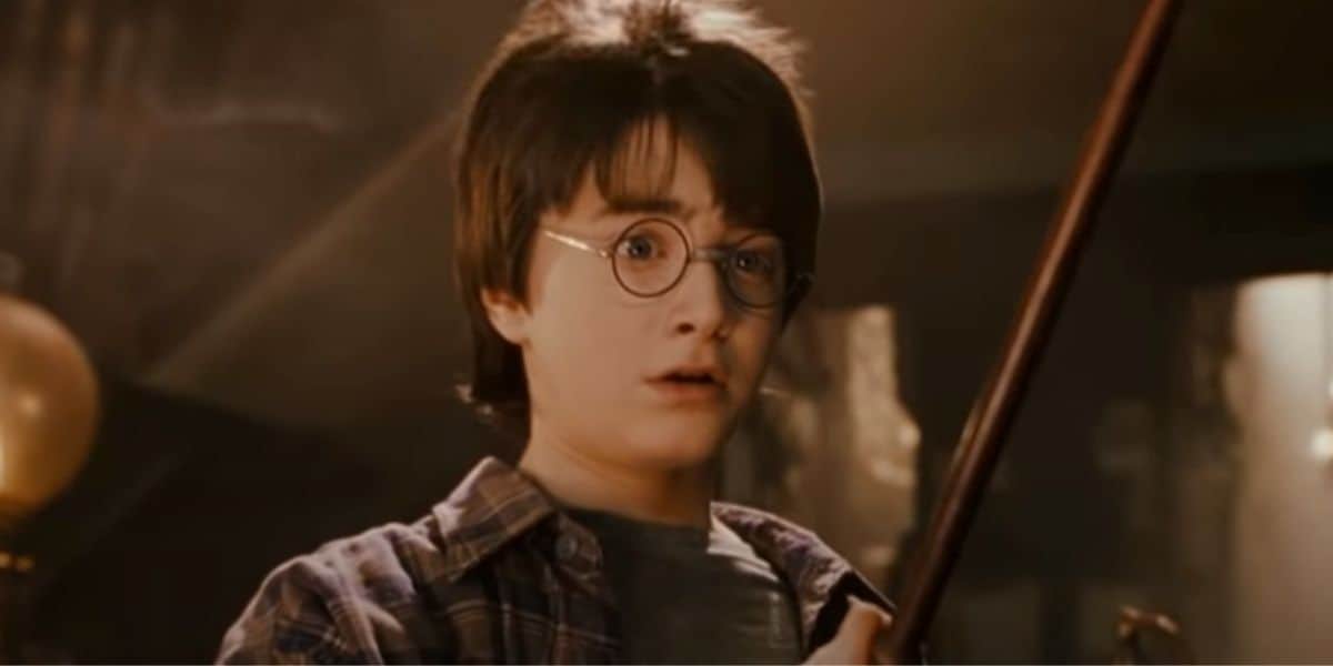 Harry Potter holding his wand for the first time