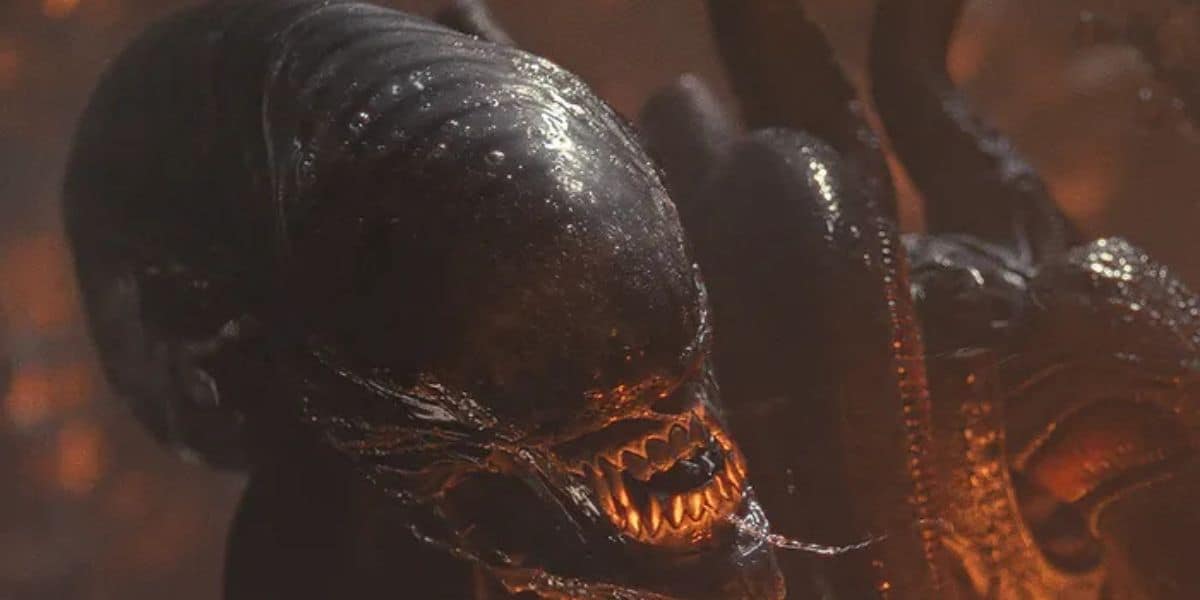 A close-up of a menacing alien creature with a glossy black exoskeleton, sharp teeth, and a ridged skull appears even more sinister under dim, reddish lighting—a scene straight out of an eerie Disney+ sci-fi fantasy.