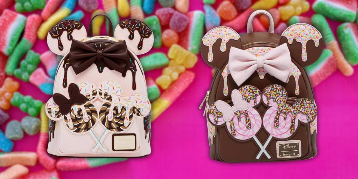 Two colorful backpacks with candy-themed Mickey ears and Minnie's signature bows, featuring delightful doughnut designs on a vibrant pink background, are surrounded by assorted chewy candies. Perfect for Disney fans with a sweet tooth!