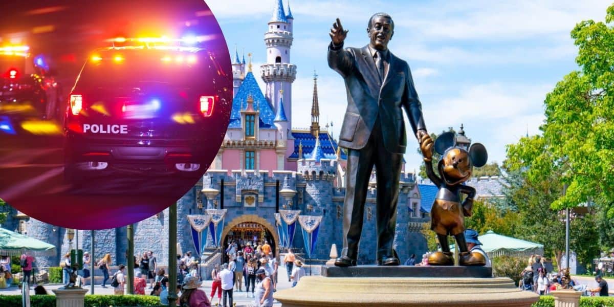 A statue of Walt Disney holding Mickey Mouse's hand stands in front of Sleeping Beauty Castle at Disneyland.