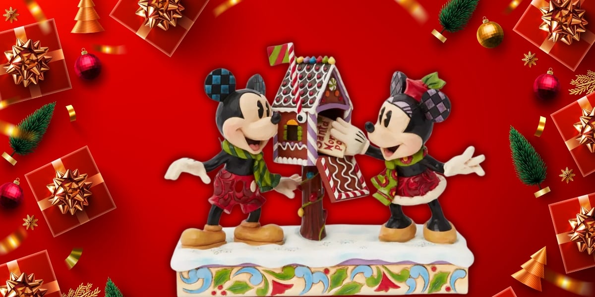 Two cartoonish mice figures, reminiscent of a Jim Shore Collectible, dressed in holiday attire, decorate a gingerbread house on a colorful base. The vibrant red background is adorned with Christmas ornaments and gift boxes, capturing the festive spirit.