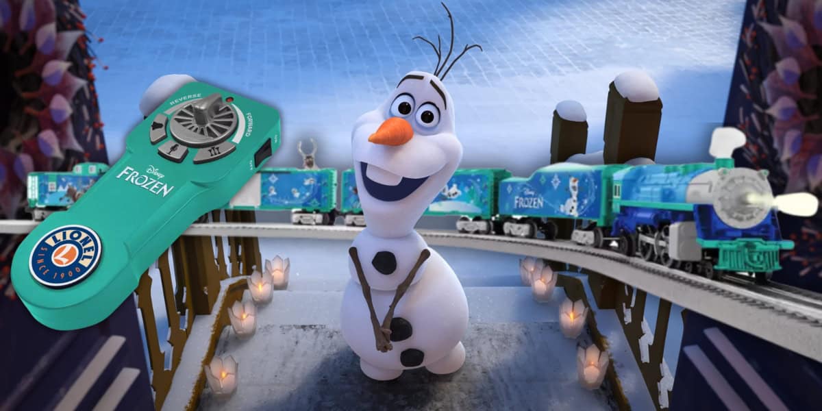 A cheerful snowman stands on a snowy bridge with lit candles on the sides. Behind him is a blue and green toy train from the LionChief Train Set, featuring "Frozen" themed designs with Olaf. A green remote control for the train is shown in the top left corner.