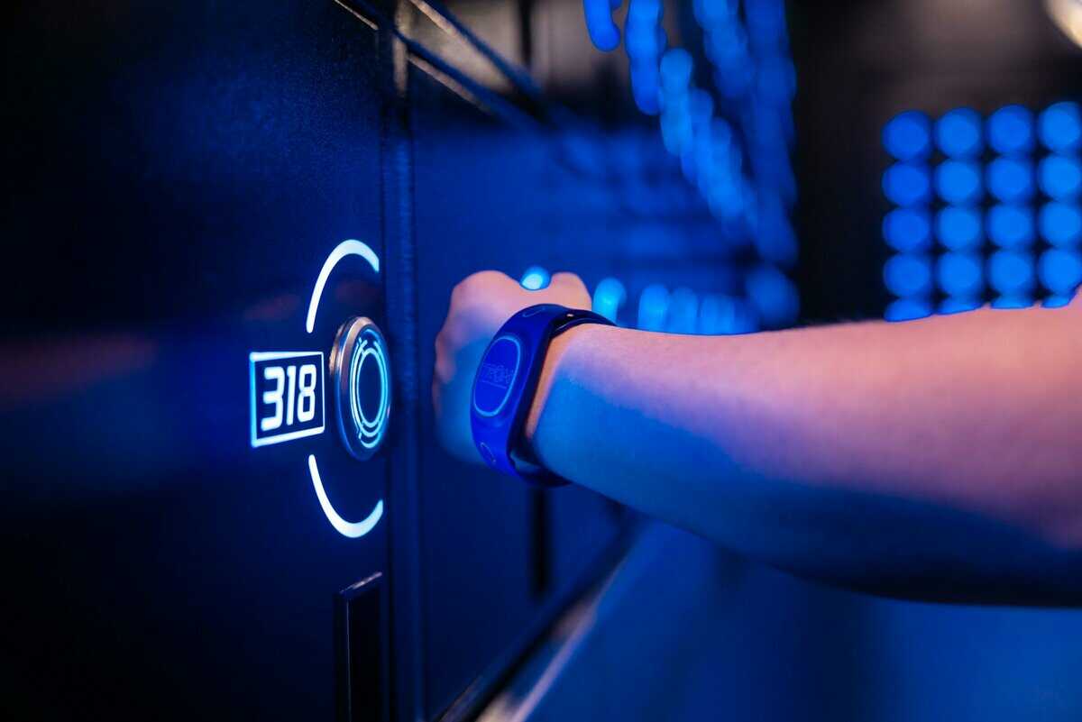 A guest using their MagicBand to access the TRON lockers