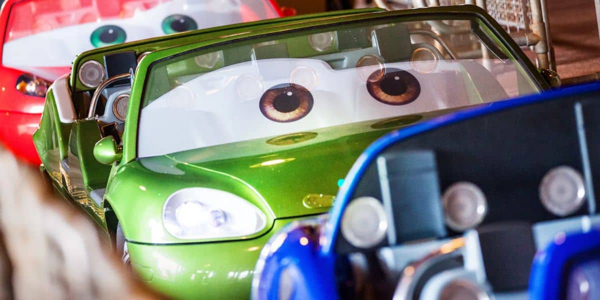 Two green and red cars with eyes.