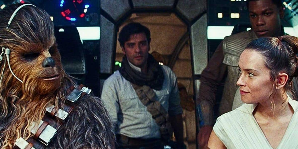 Rey, Poe, Fin, and Chewbacca sitting inside the cockpit of the Millennium Falcon