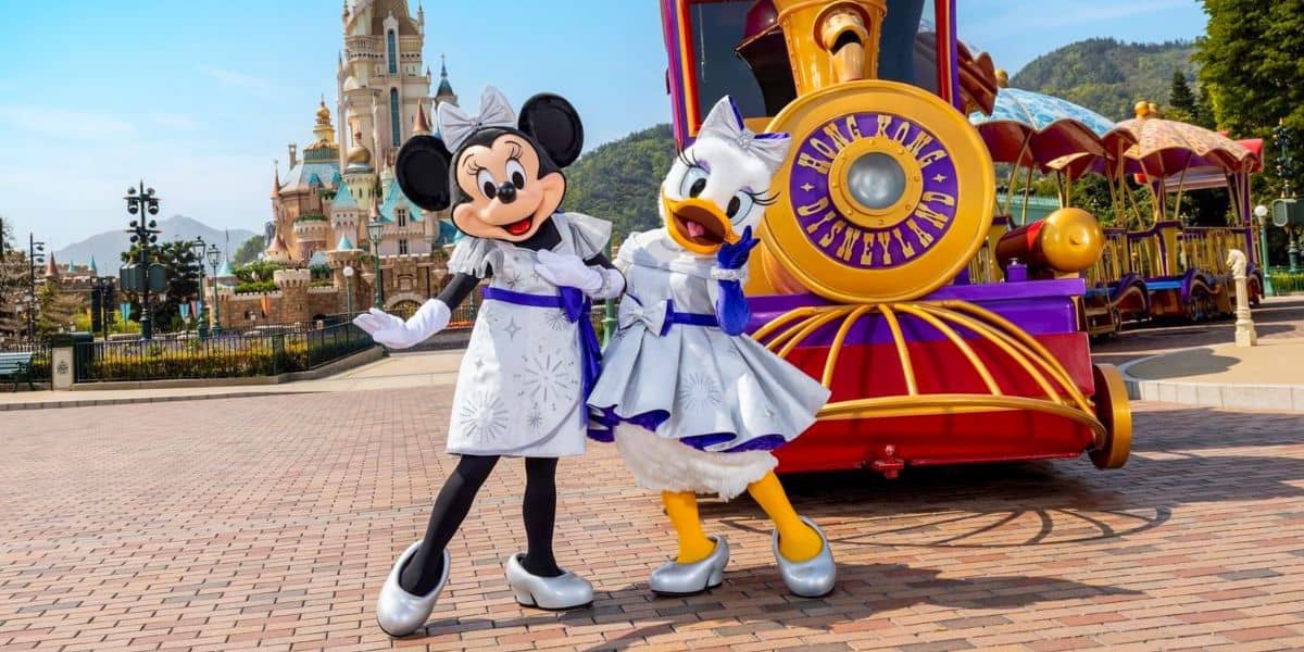 Minnie Mouse and Daisy Duck in front of a parade float