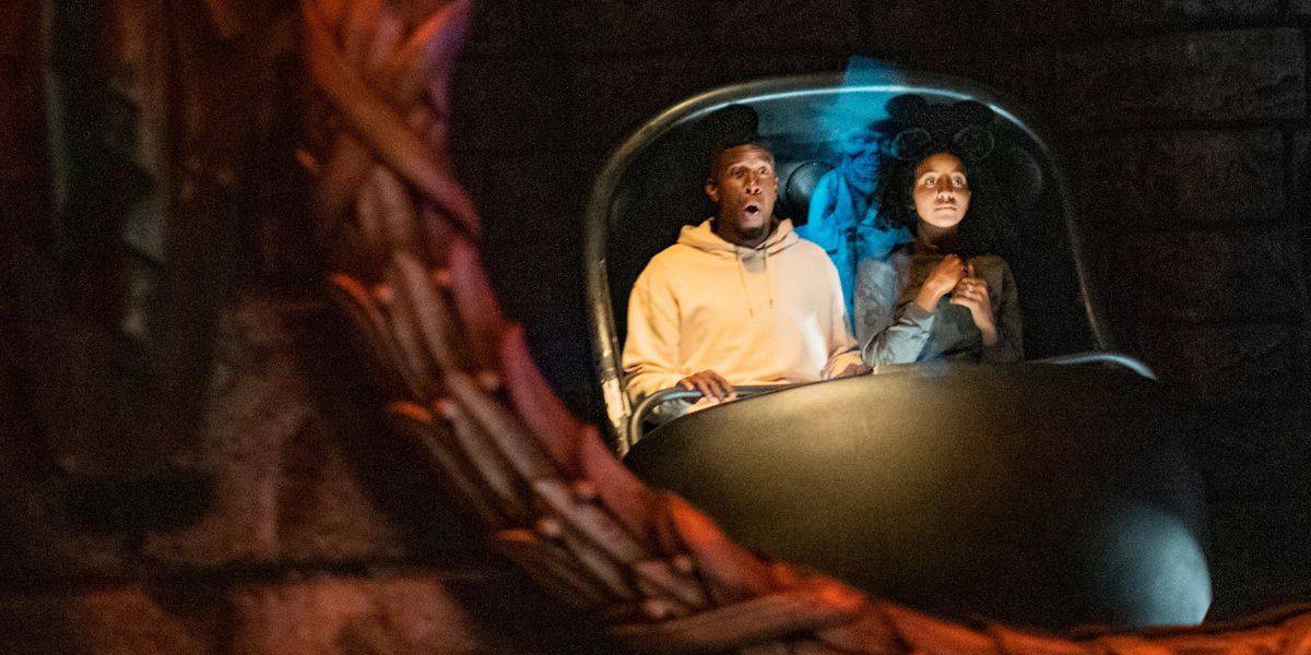 A man and woman ride in a Doom Buggy on the Haunted Mansion at Disneyland