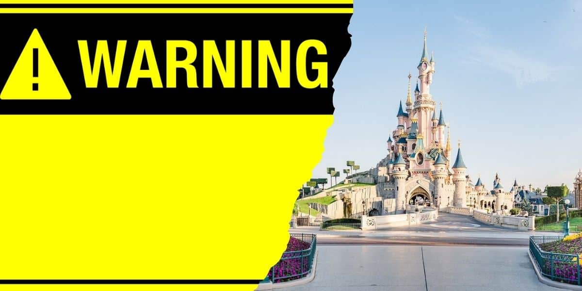 Graphic divided in half; on the left, a bold yellow section with text "a warning" in black, and on the right, an image of a picturesque castle at Disneyland Paris with a clear blue sky.