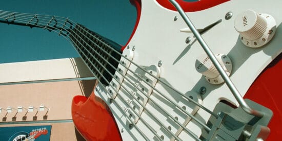 A guitar hanging on a wall