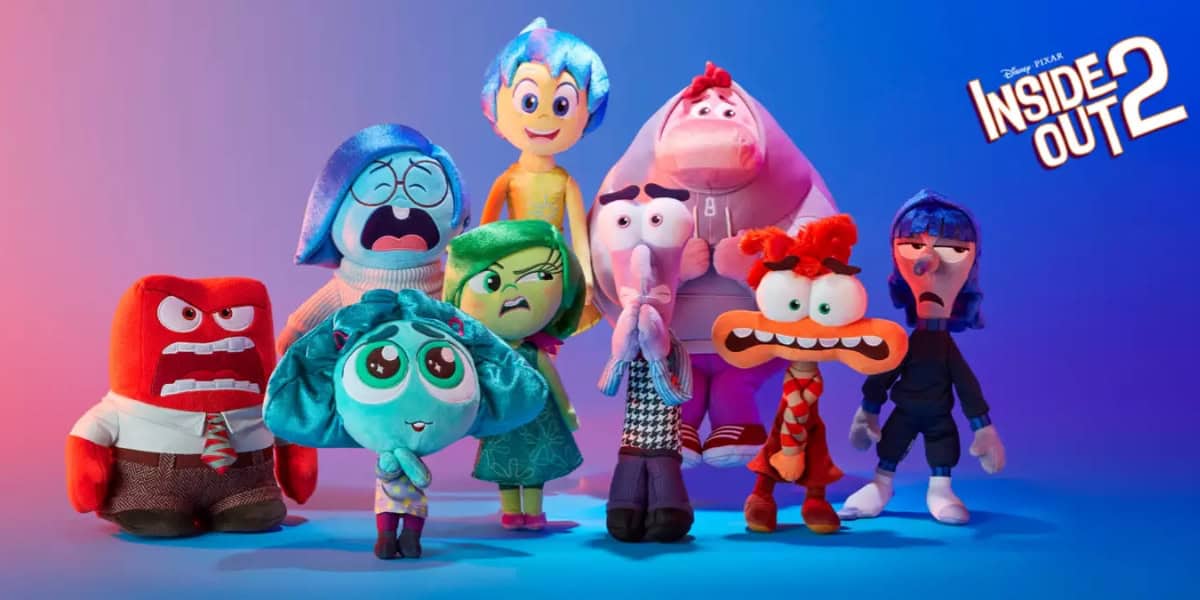 A promotional image for "Inside Out 2," showcasing plush toy characters against a gradient blue and purple background, evokes the magic of Disneyland. The characters, each representing different emotions, are arranged in two rows, with the movie title displayed in the top right corner.