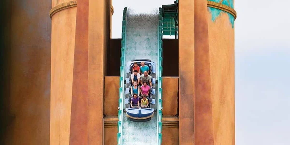 A group of people in a boat ride down a steep water slide at SeaWorld San Diego.