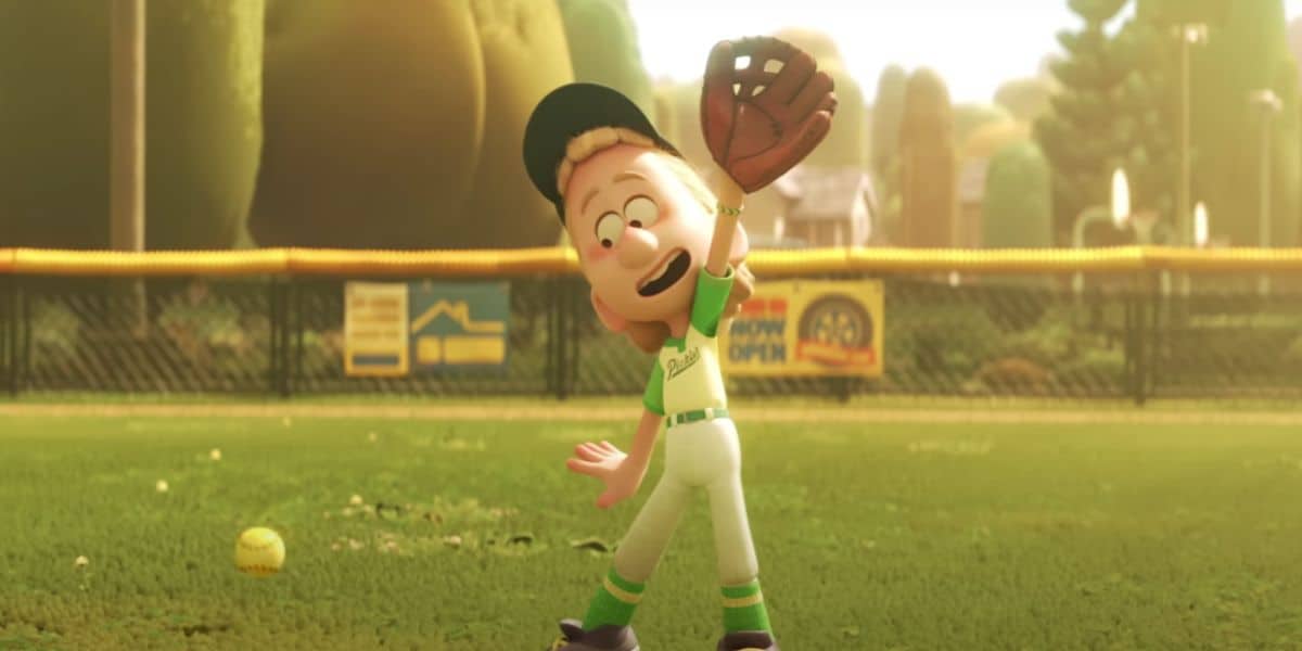 Animated character wearing a baseball cap, green and white uniform, and glove, looking up while standing on a baseball field. The character looks surprised as a softball falls near their feet. The backdrop, reminiscent of a Pixar project, includes an outfield fence and trees.