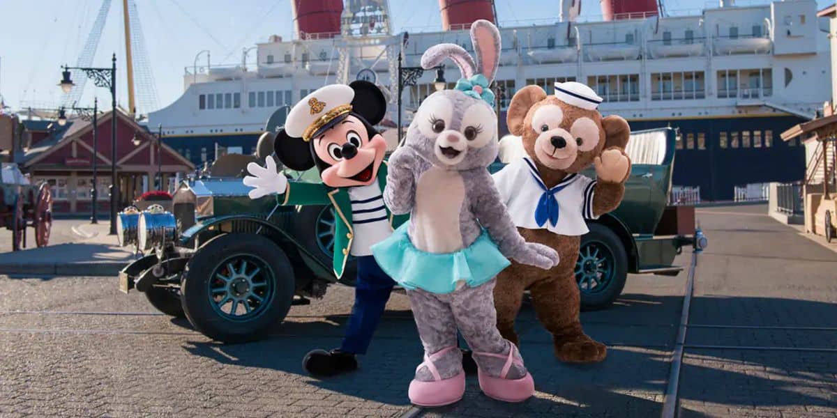 Mickey, Duffy, and StellaLou in front of a car and boat