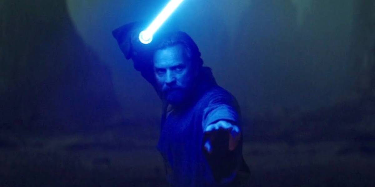 Obi-Wan Kenobi glowing by the blue light of his lightsaber