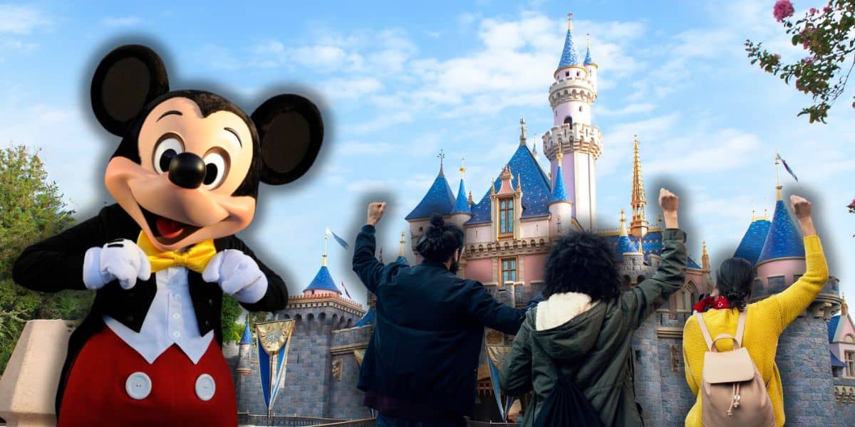 Mickey Mouse with Disneyland cast members in front of the Sleeping Beauty Castle in Disneyland Park.