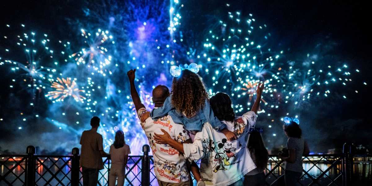 Guests watching the Luminous The Symphony of Us fireworks at EPCOT in Walt Disney World