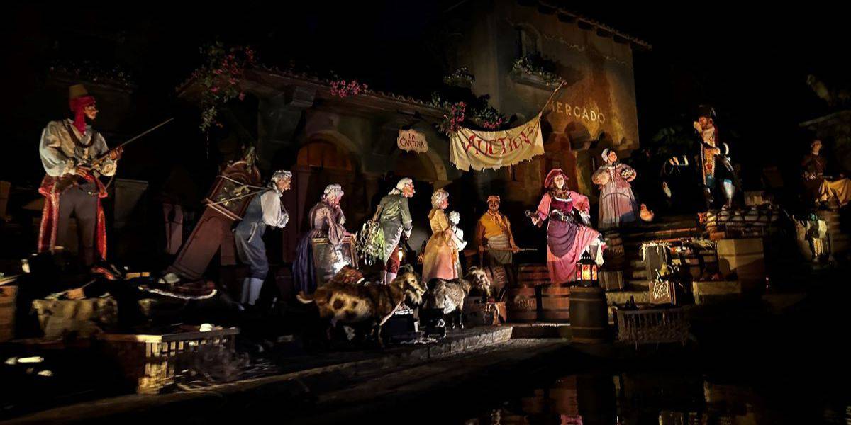 Auction scene featuring Pirate Redd, the auctioneer, and townspeople in the Pirates of the Caribbean ride at Magic Kingdom in Walt Disney World Resort
