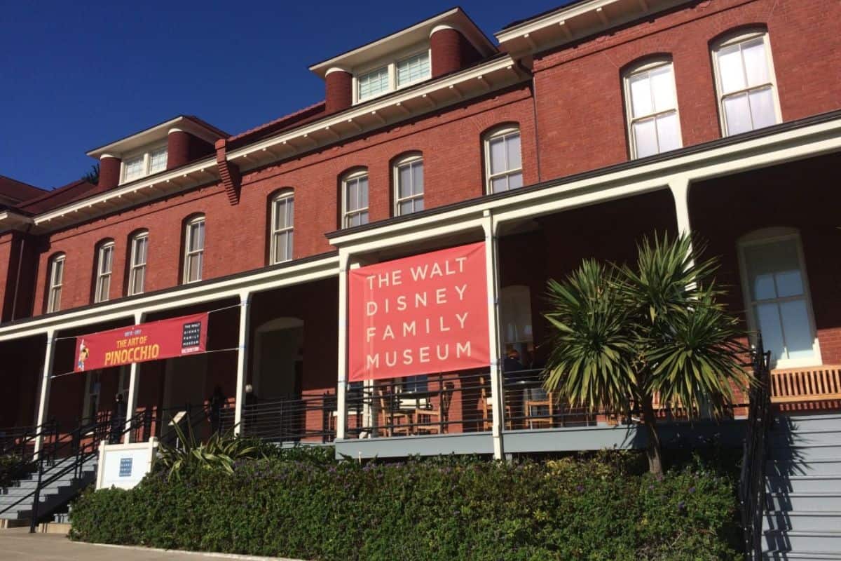 The Walt Disney Family Museum, nestled in a historic red-brick building with white-trimmed windows.