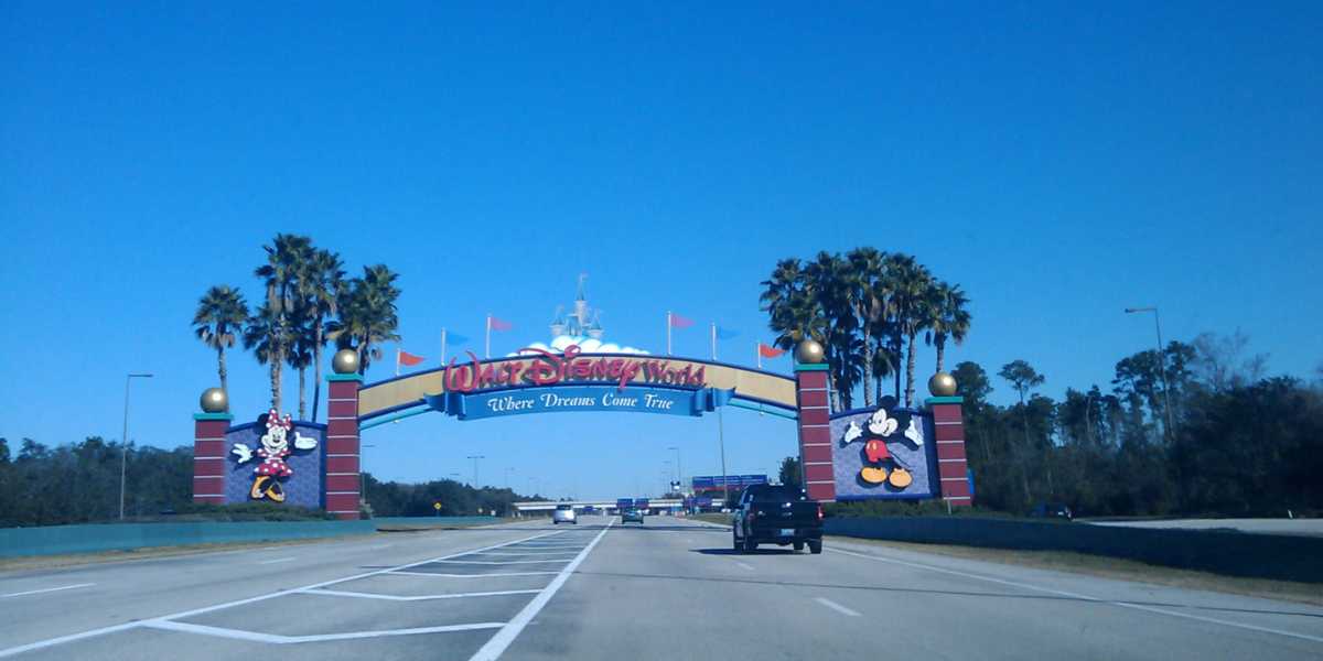 Cars driving through the Walt Disney World Resort gates as your vacation begins.
