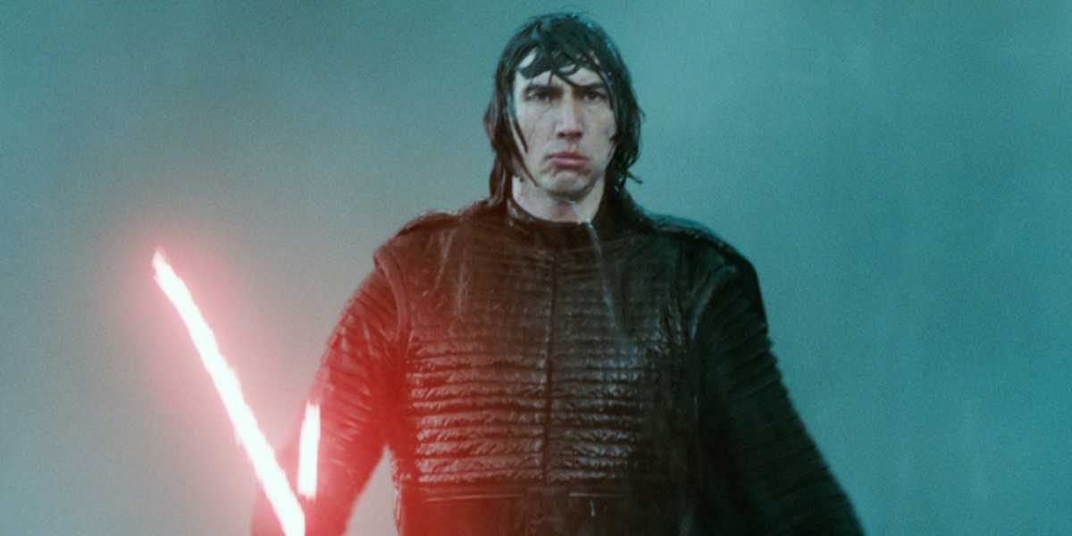 Adam Driver as Kylo Ren holding a red lightsaber