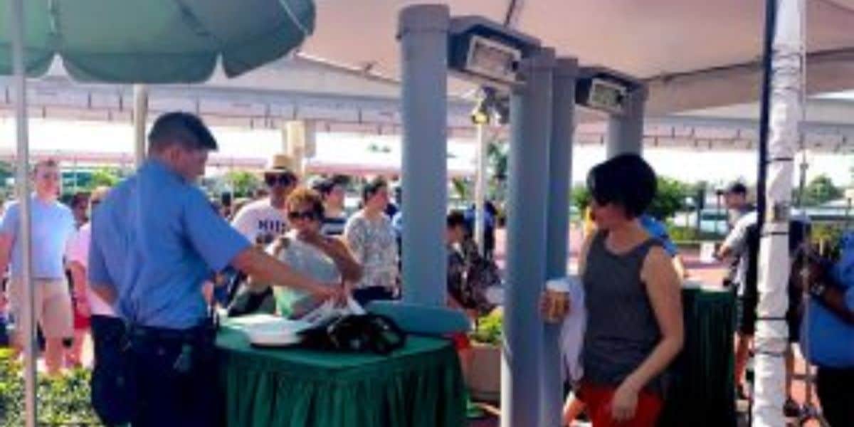 People wait in line at a security checkpoint at Walt Disney World Resort.