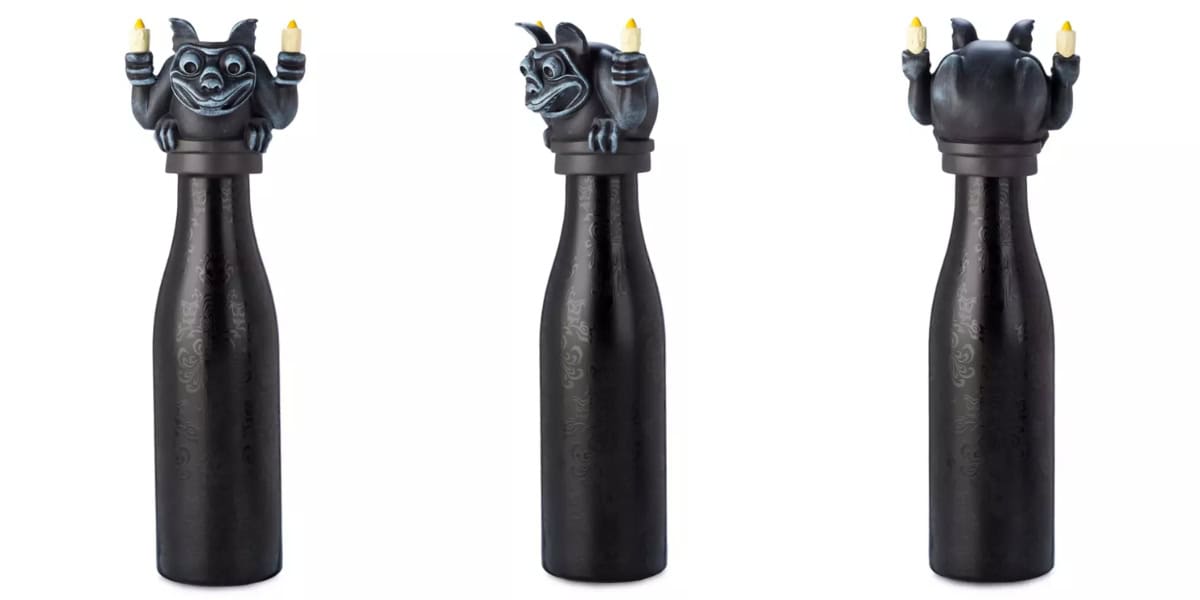 A dark, sleek bottle with a decorative topper featuring a whimsical, dark-colored creature holding two candles. The image shows the bottle from three angles: front, side, and back, highlighting the detailed and expressive design of the creature. This is one of those Last-Minute Must-Haves for Mickey’s Not-So-Scary Halloween Party!