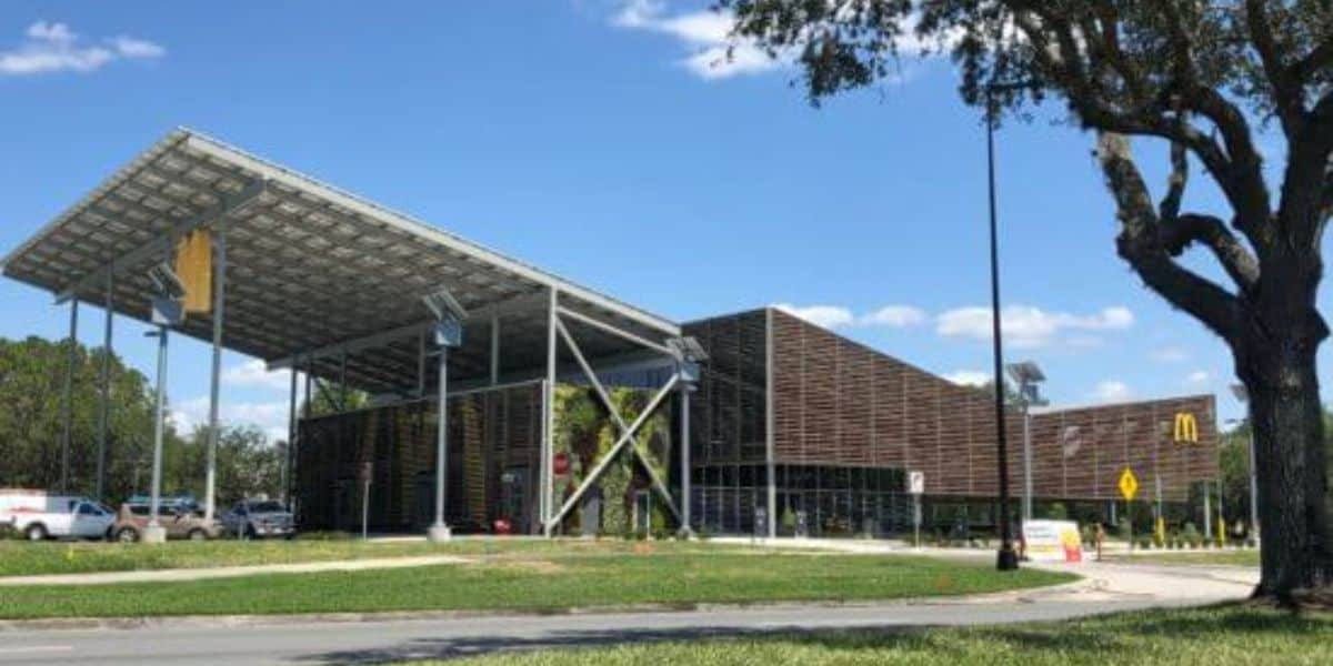 A modern McDonald’s building with a large solar panel roof at Walt Disney World Resort.