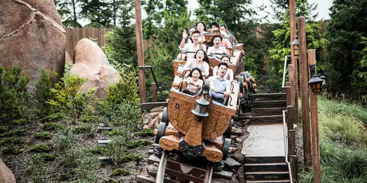 Guests ride Seven Dwarfs Mine Train at Shanghai Disneyland