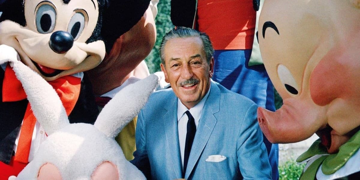 Walt Disney smiling alongside Disney characters.