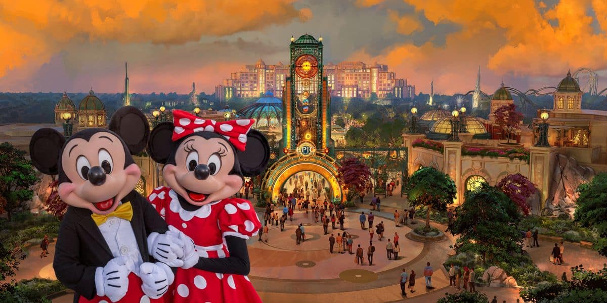 Mickey Mouse and Minnie Mouse stand in front of Epic Universe