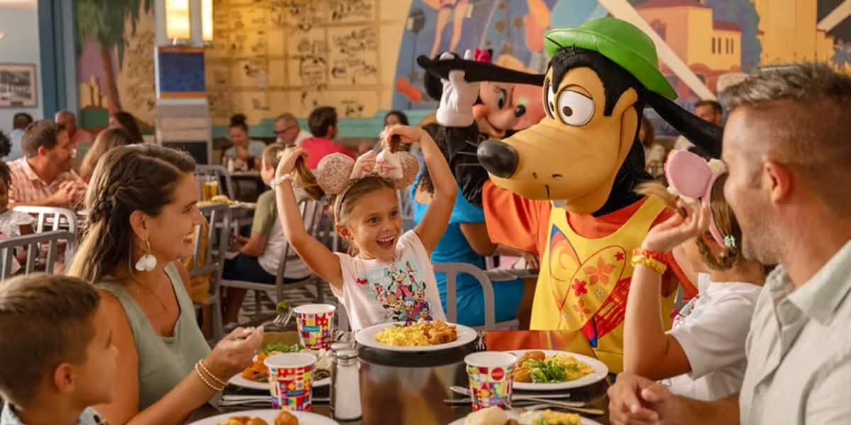 A family greets Goofy at a character dining experience as Disney World resort hotels receive special accommodations for Disney hotels.