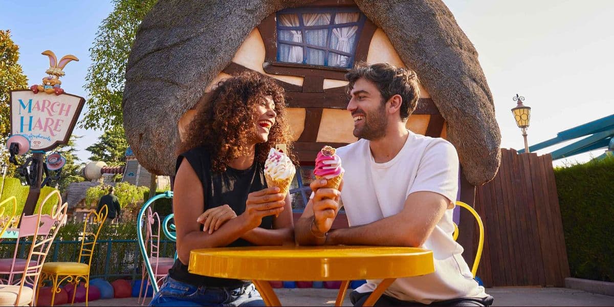 Two adults sat in Fantasyland at Disneyland Paris