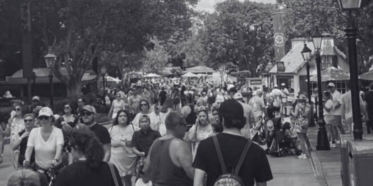 A black and white photo of crowds in the EPCOT World Showcase at Disney World.
