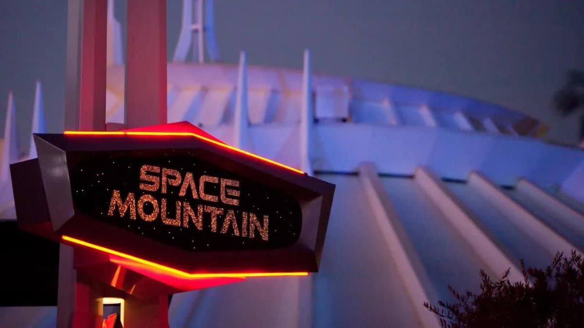 A sign for Space Mountain in front of the ride building.