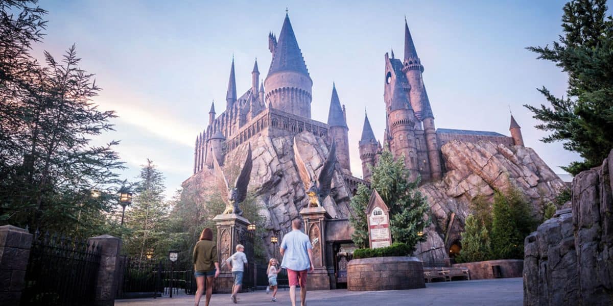 A family walks towards Hogwarts Castle in The Wizarding World at Universal